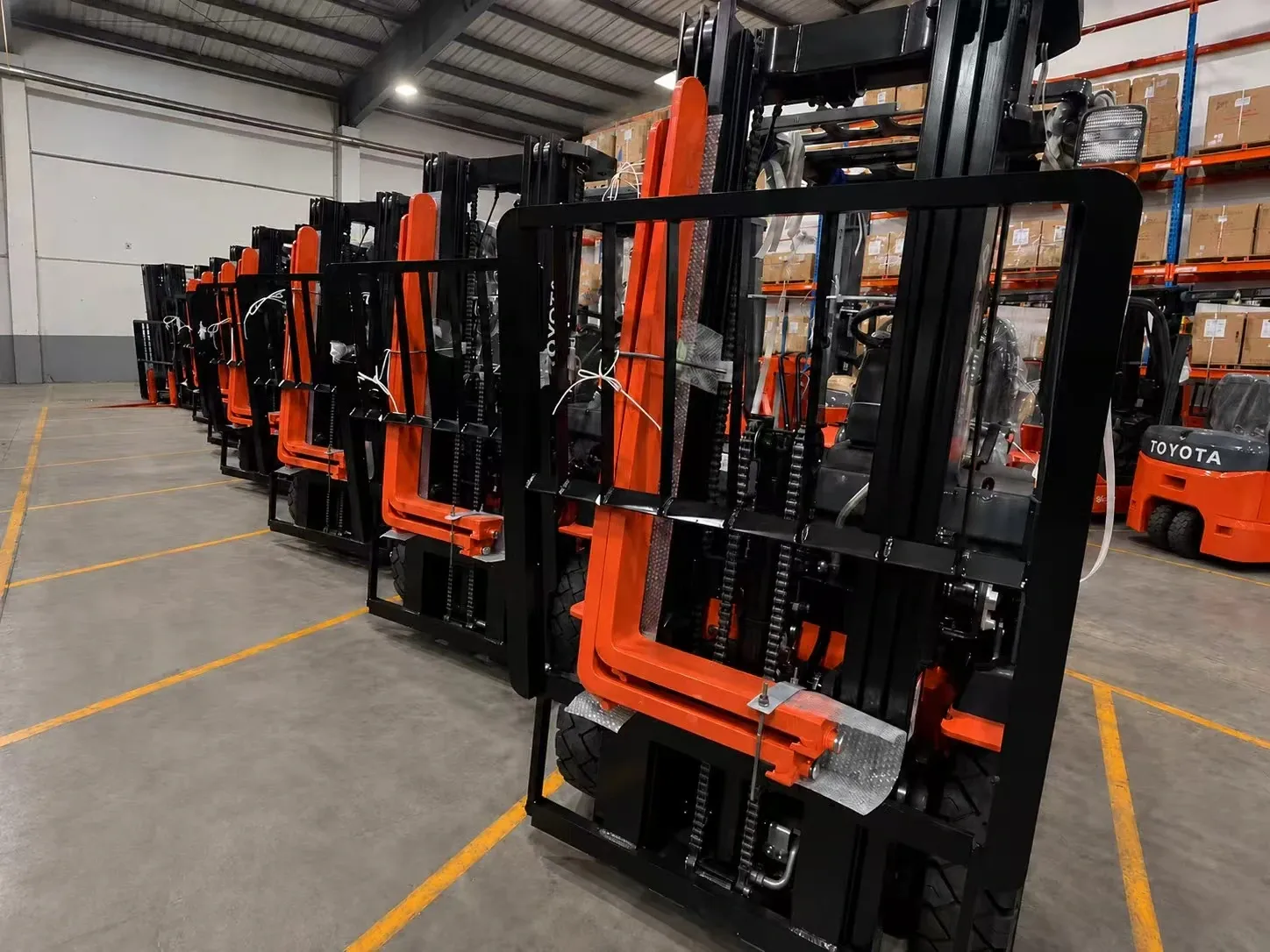 WAREHOUSE STAGING, Forklifts prepared for export.