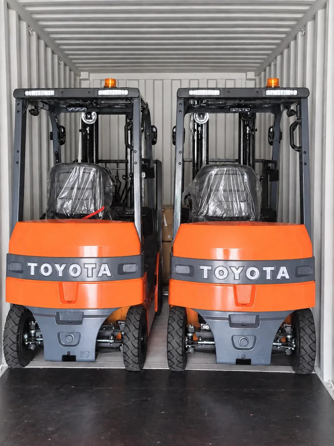 COMPLETE FORKLIFTS, Two forklifts positioned for export.